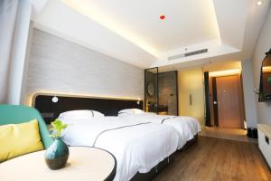 Voodi või voodid majutusasutuse Hangzhou Yuqi Hotel - West Lake Scenic Area Branch toas