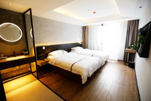 Voodi või voodid majutusasutuse Hangzhou Yuqi Hotel - West Lake Scenic Area Branch toas