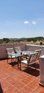 a patio with a table and chairs on a roof at Edificio duplex Can Roses in Moscari