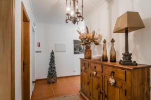 a room with a christmas tree on a dresser at Burgo Dom Afonso V Golf & Beach Resort in Casal da Lagoa Seca