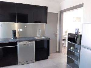 a kitchen with a sink and a microwave at MyHome Basel 1B44 in Saint-Louis
