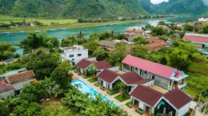 an aerial view of a village next to a river at Son Doong Bungalow in Phong Nha