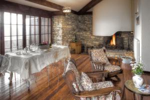 a dining room with a table and chairs and a fireplace at Casa Vacanze Assisi in Spello
