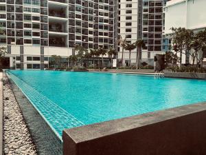 a large swimming pool in front of a building at Stellar Homes at iCity - with WiFi and 2 Private Carparks in Shah Alam