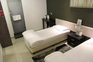 Postel nebo postele na pokoji v ubytování M Design Hotel @ Seri Kembangan