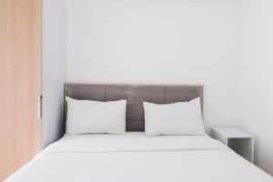 Ένα ή περισσότερα κρεβάτια σε δωμάτιο στο Comfy Studio at M-Town Gading Serpong Apartment By Travelio +8 φωτογραφίες