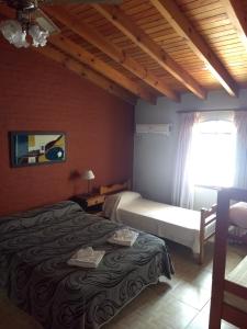 a bedroom with a bed and a window with a window at Hotel Gala in Villa Carlos Paz