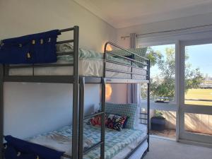 a room with two bunk beds and a window at Play@PortMacq in Port Macquarie