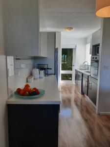 a kitchen with a plate of fruit on a counter at Play@PortMacq in Port Macquarie
