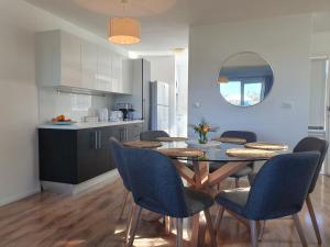 a kitchen and dining room with a table and chairs at Play@PortMacq in Port Macquarie
