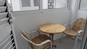 a table and chairs in a room with a window at Kuća Radović in Budva