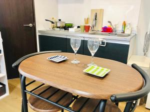a wooden table with two wine glasses on it at 板橋 RCアネックス Rc207 in Tokyo +30 photos