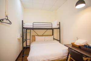 Postel nebo postele na pokoji v ubytování Douzi Hotel-Xpark. Gloria Outlets. Taoyuan MRT