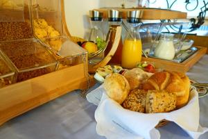 a table topped with a basket of bread and juice at Alkira in Sankt Anton am Arlberg