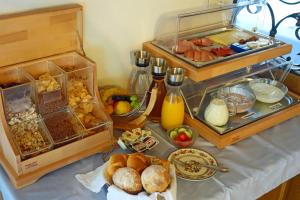 a table with a buffet of breakfast foods and juice at Alkira in Sankt Anton am Arlberg