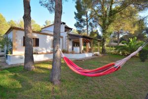 a hammock in front of a house at 020 Casa Trevol ETV6474 by Mallorca Charme in Alcudia