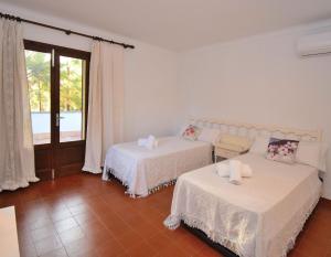 a living room with two beds and a window at 020 Casa Trevol ETV6474 by Mallorca Charme in Alcudia