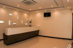 a waiting room with a television on a wall at The Pioneer in Visakhapatnam