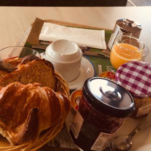 a breakfast table with a basket of bread and orange juice at La bagatelle in Saint-Michel-de-Chaillol +17 photos