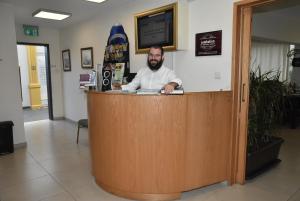 a man standing at a counter in a store at Rimon Cyprus Israeli Kosher Rooms in Larnaca