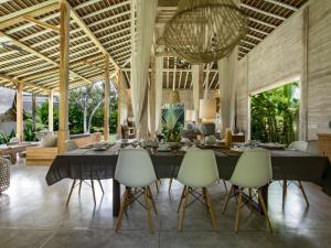 a dining room with a large table and chairs at Villa Alea in Kerobokan