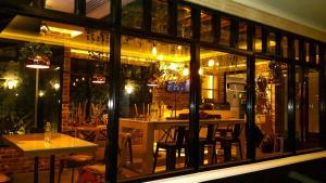 a restaurant with a large window with tables and chairs at Siam Bright Suite in Bangkok