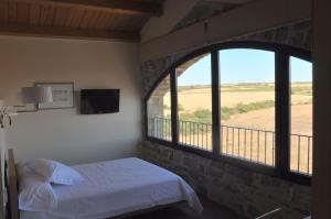 A bed or beds in a room at La Torre Del Codina