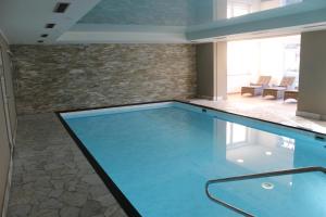 a swimming pool in a room with a brick wall at Hotel Muschinsky in Bad Lauterberg