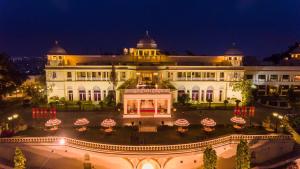 a large white building with a courtyard at night at The Lalit Laxmi Vilas Palace in Udaipur