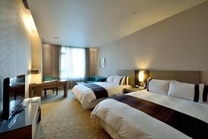 Postel nebo postele na pokoji v ubytování Shinkansen Grand Hotel + 37 fotografií