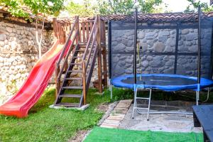 a playground with a slide and a swing set at Banskovilla Zlateva House in Bansko