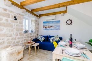 a living room with a blue couch and a table at Apartments Korita in Maranovići