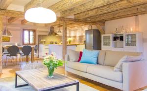 a living room with a couch and a table at Altendorfer Vorwerk - Ferienapartments in Altendorf