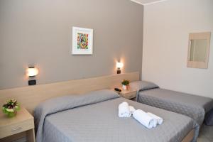 Postel nebo postele na pokoji v ubytování Hotel Excelsior