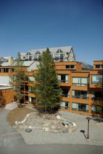 a large apartment building with a garden in front of it at Huntley Lodge at Big Sky Resort in Big Sky