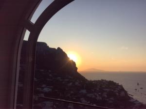 a view of the sun setting over the ocean from an airplane at Longano 35 in Capri