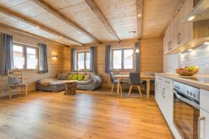a kitchen and living room with a couch and a table at Landhaus Panorama in Bad Hindelang