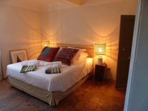 a bedroom with a bed with two pillows on it at La Civadière in Cogolin +16 photos