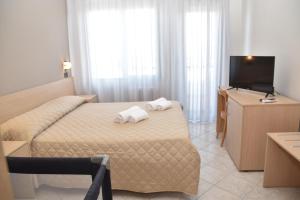 Postel nebo postele na pokoji v ubytování Hotel Excelsior