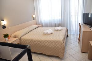 Postel nebo postele na pokoji v ubytování Hotel Excelsior