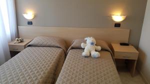 Postel nebo postele na pokoji v ubytování Hotel Excelsior
