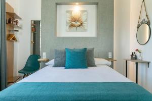 ein Schlafzimmer mit einem großen Bett mit blauen Kissen in der Unterkunft Romar Montesa 3 in Málaga