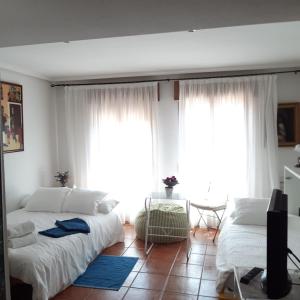 A bed or beds in a room at Pequeño y Coqueto Piso en Riaza