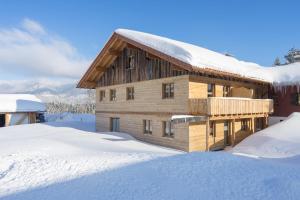 a log cabin in the snow with snow covered at Landhaus Panorama in Bad Hindelang