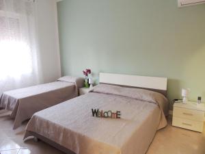 Posteľ alebo postele v izbe v ubytovaní FIORI E COLORI