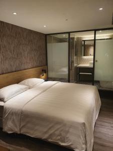 Ένα ή περισσότερα κρεβάτια σε δωμάτιο στο City Suites - Taoyuan Station