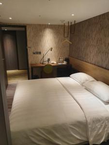 Ένα ή περισσότερα κρεβάτια σε δωμάτιο στο City Suites - Taoyuan Station