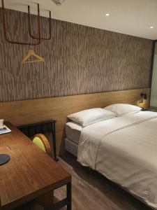 Ένα ή περισσότερα κρεβάτια σε δωμάτιο στο City Suites - Taoyuan Station