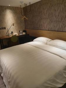 Ένα ή περισσότερα κρεβάτια σε δωμάτιο στο City Suites - Taoyuan Station