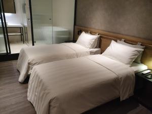 Ένα ή περισσότερα κρεβάτια σε δωμάτιο στο City Suites - Taoyuan Station